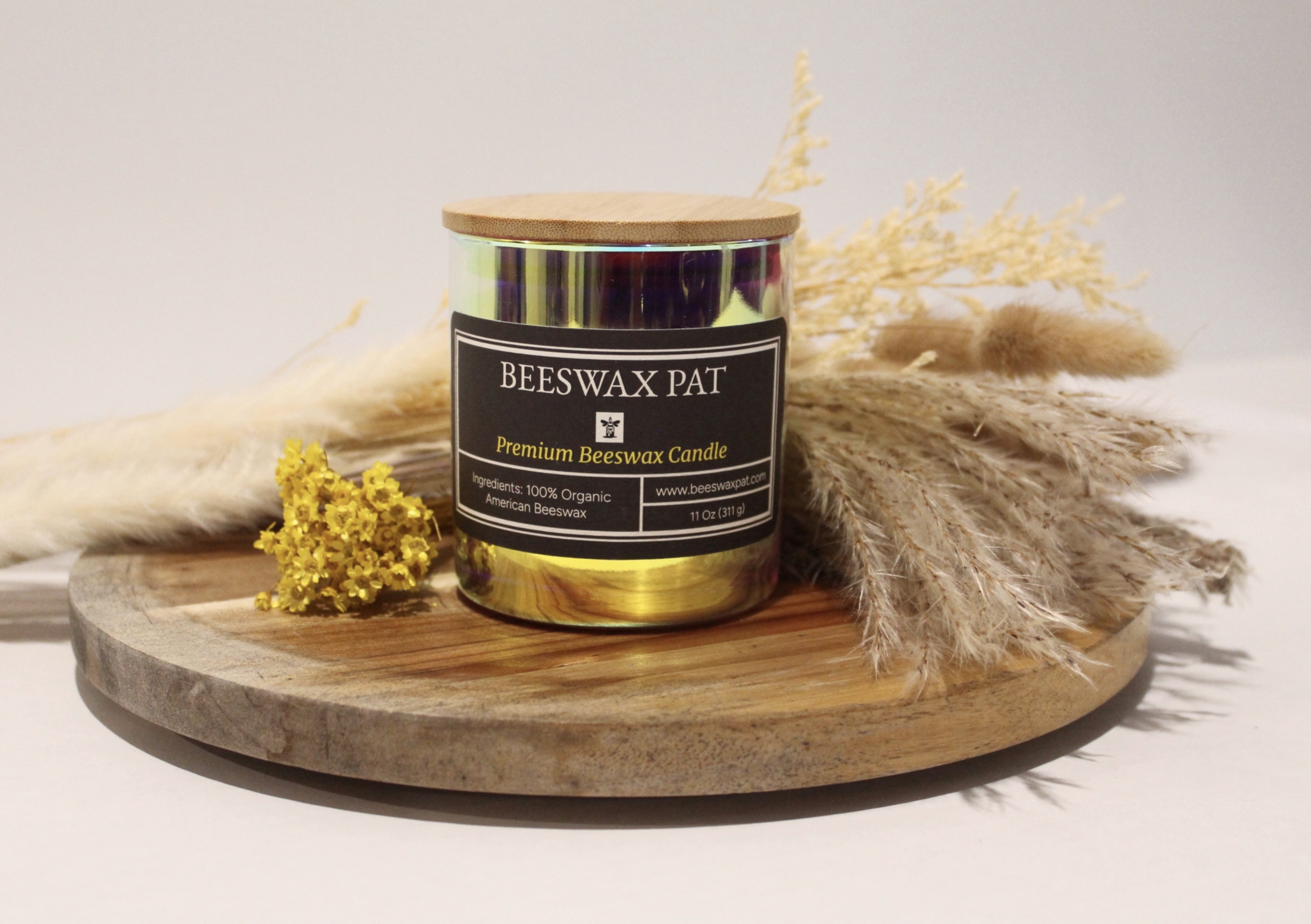 Old Line beeswax candle with bamboo lid, iridescent gold jar, black label reading Beeswax Pat Premium Beeswax Candle